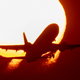 A plane in front of the sun. It’s a metaphor.